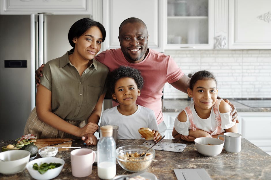 Happy family embracing in their kitchen, feeling hopeful